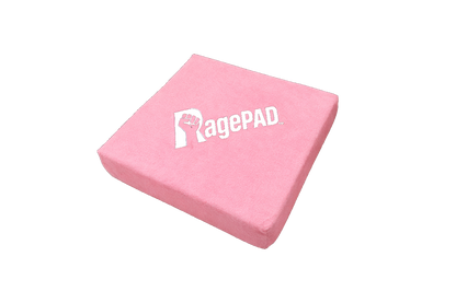Pink RagePAD stress relief pad for gamers, soft square cushion on black background